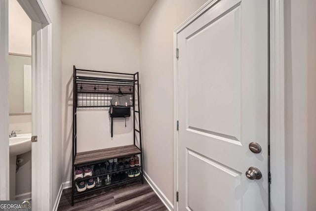 interior space with baseboards and dark wood-style flooring