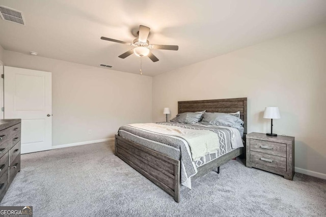 carpeted bedroom with visible vents, baseboards, and a ceiling fan