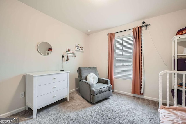 living area featuring carpet and baseboards