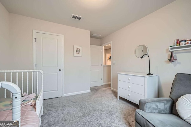 carpeted bedroom featuring visible vents and baseboards