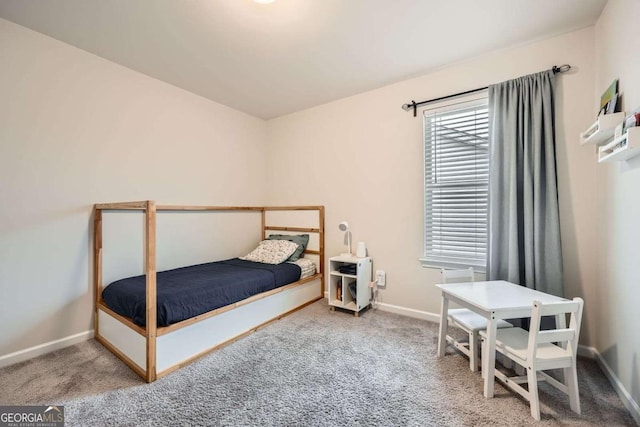 bedroom featuring carpet and baseboards