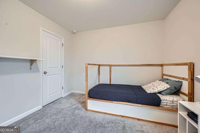 bedroom featuring baseboards and carpet