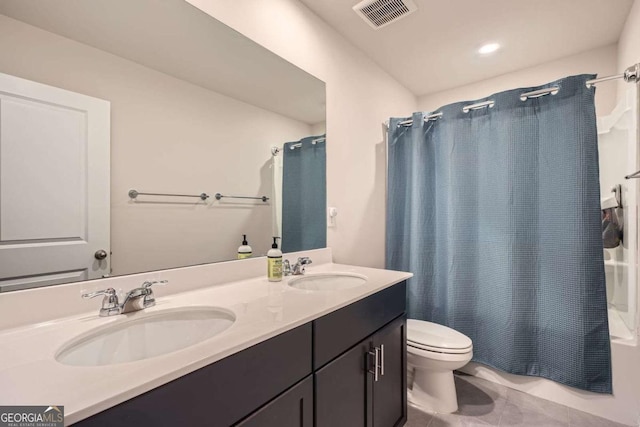 bathroom featuring tile patterned floors, visible vents, toilet, and a sink