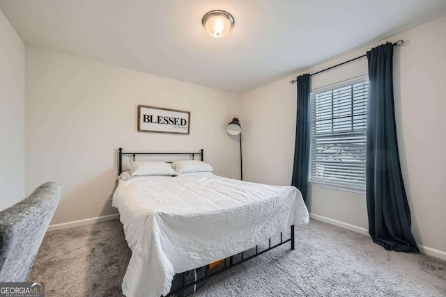 carpeted bedroom featuring baseboards