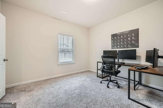 carpeted home office with baseboards and visible vents