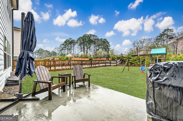 view of patio with grilling area, a playground, and fence