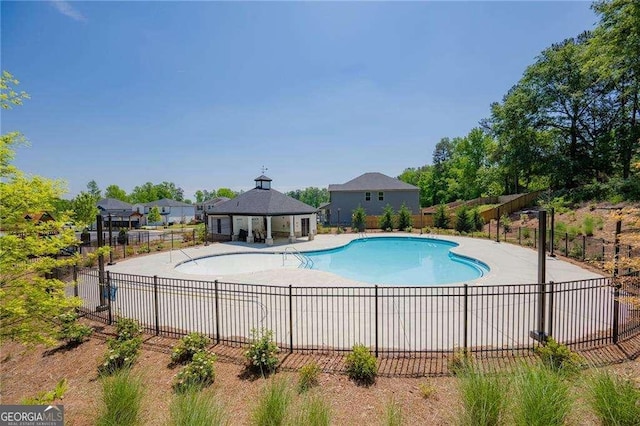 community pool featuring a gazebo, a patio, and fence