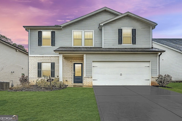 traditional-style house with brick siding, concrete driveway, a front yard, cooling unit, and an attached garage