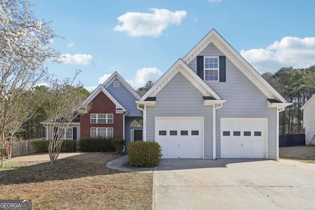 traditional-style house featuring concrete driveway and a garage