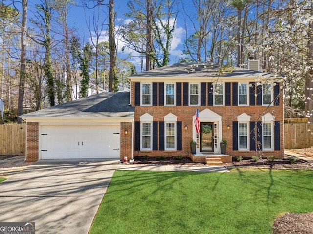 view of front facade featuring an attached garage, fence, brick siding, and driveway