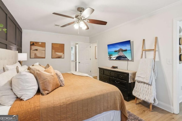 bedroom with light wood finished floors, visible vents, crown molding, ceiling fan, and baseboards