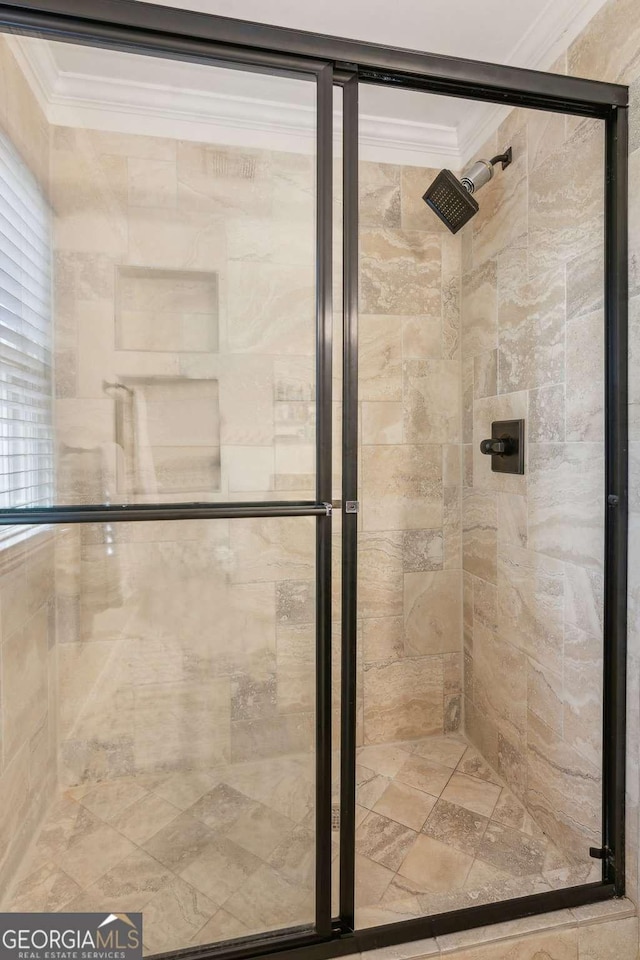 bathroom featuring crown molding and a stall shower