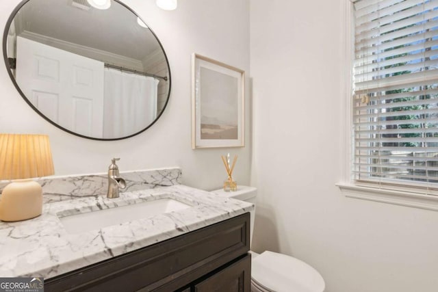 bathroom featuring toilet and vanity