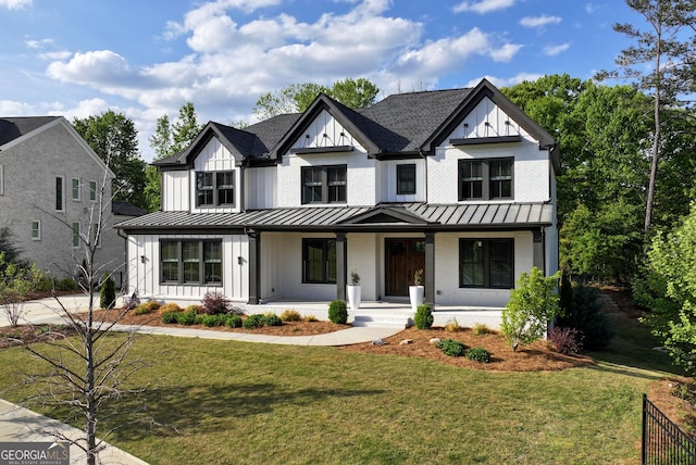 modern farmhouse with board and batten siding, covered porch, a standing seam roof, and metal roof