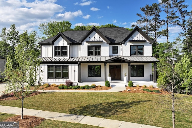 modern inspired farmhouse with board and batten siding, roof with shingles, and a standing seam roof