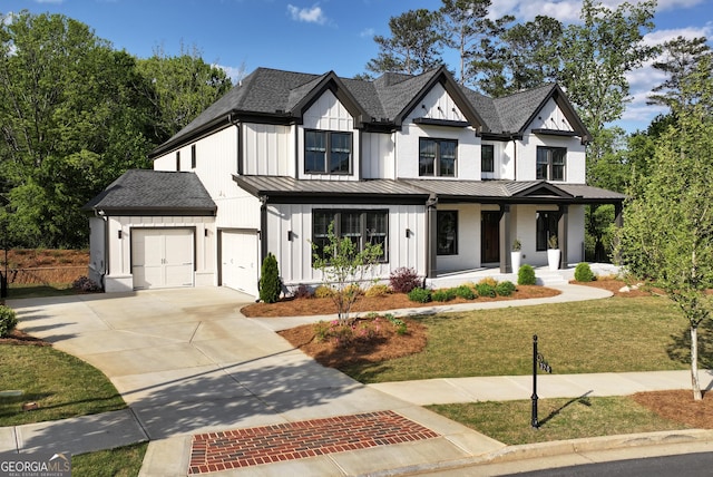 modern farmhouse style home featuring a front lawn, driveway, board and batten siding, a porch, and a standing seam roof