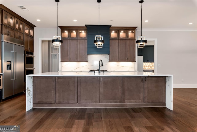 kitchen with visible vents, appliances with stainless steel finishes, light countertops, and a sink