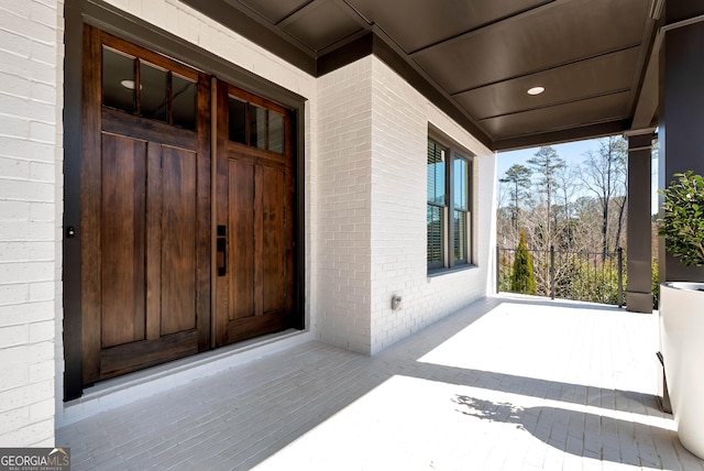 view of exterior entry featuring brick siding