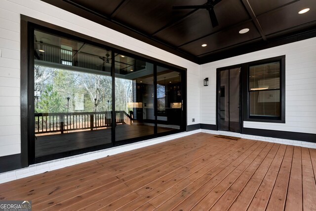 wooden terrace featuring ceiling fan