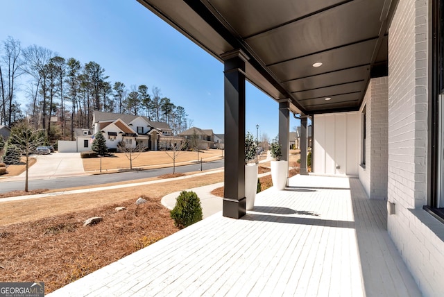 view of patio with a residential view and a porch