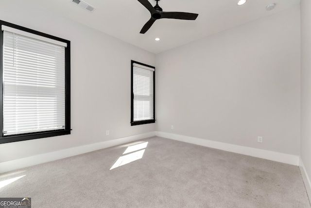 carpeted spare room with visible vents, recessed lighting, a ceiling fan, and baseboards