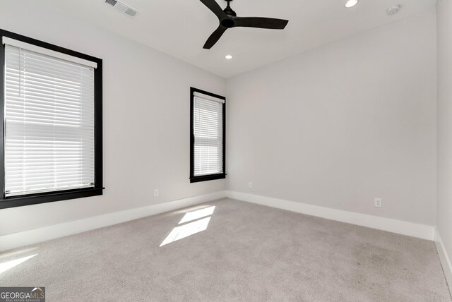 unfurnished room with a ceiling fan, visible vents, carpet floors, and recessed lighting