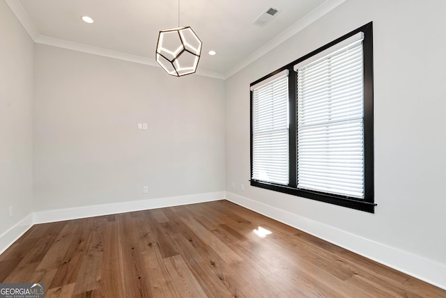 unfurnished room with baseboards, visible vents, recessed lighting, wood finished floors, and ornamental molding
