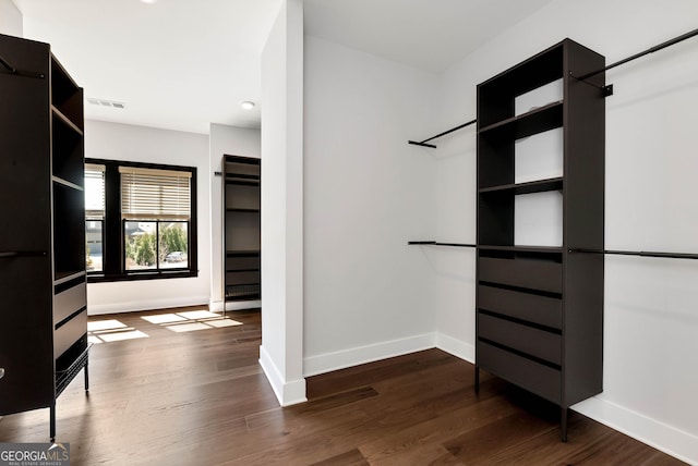 spacious closet featuring dark wood finished floors and visible vents