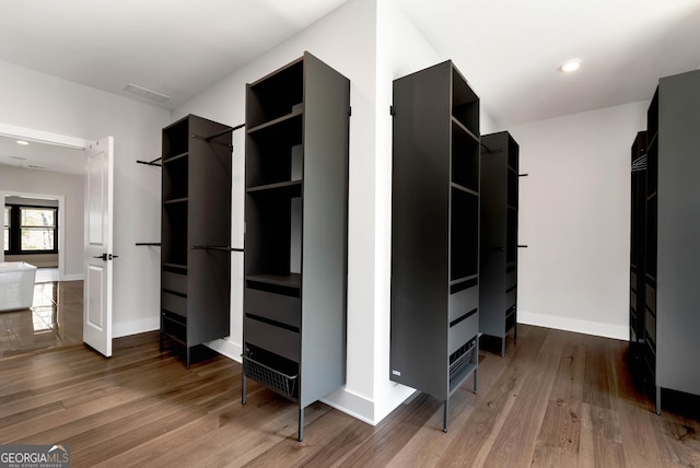 walk in closet with wood finished floors and visible vents