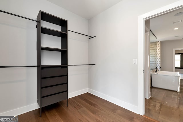 walk in closet featuring visible vents and dark wood-style flooring