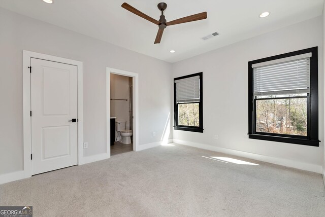 unfurnished bedroom with recessed lighting, visible vents, multiple windows, and carpet