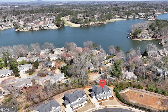 drone / aerial view featuring a residential view and a water view