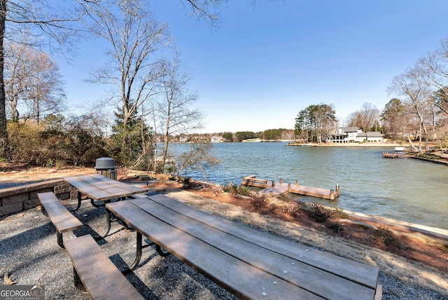 exterior space with a water view and a dock
