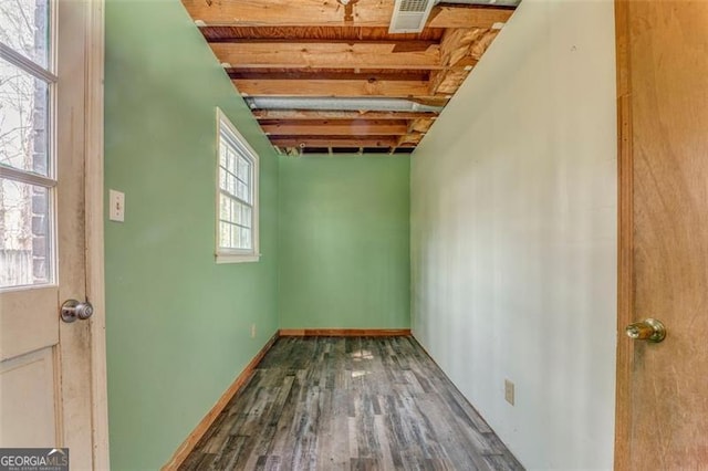 interior space featuring visible vents, baseboards, and wood finished floors