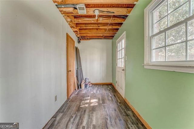 interior space with visible vents, baseboards, and wood finished floors