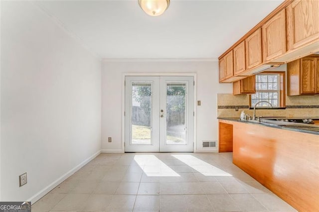 kitchen with visible vents, backsplash, ornamental molding, and french doors