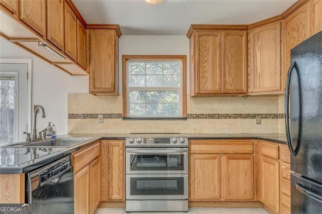 kitchen with black appliances, a peninsula, backsplash, and a sink