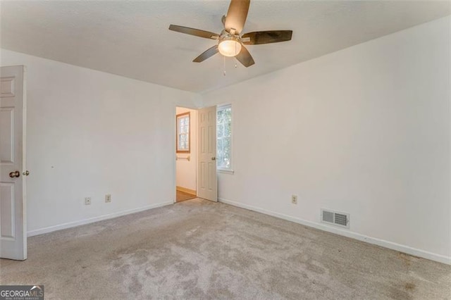 unfurnished room featuring visible vents, baseboards, and carpet