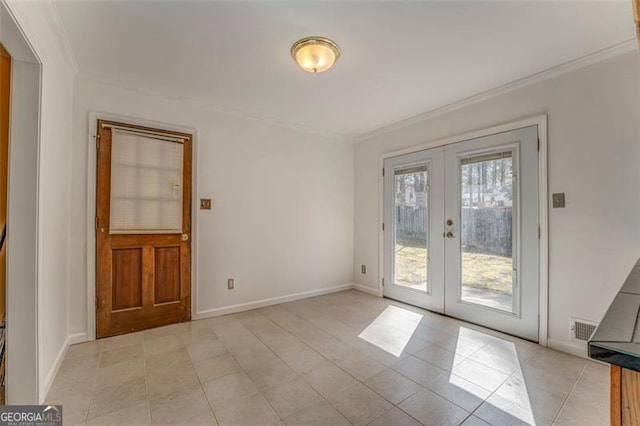 doorway featuring visible vents, baseboards, ornamental molding, and french doors