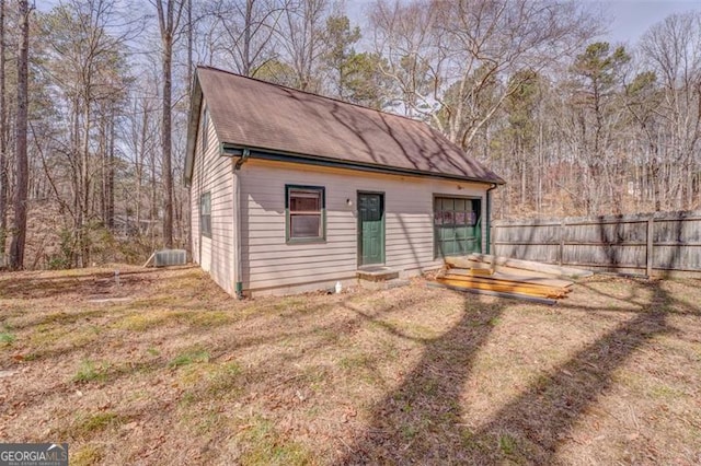 view of outbuilding with fence