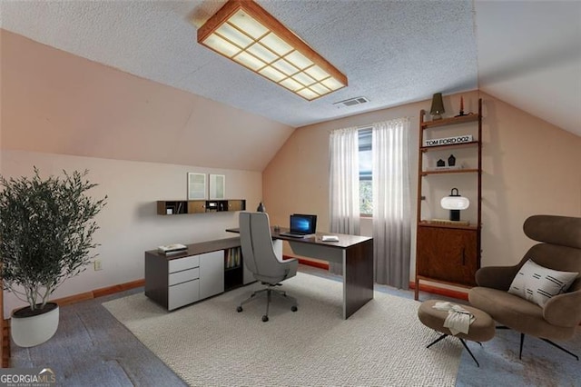 office featuring baseboards, a textured ceiling, lofted ceiling, and hardwood / wood-style floors