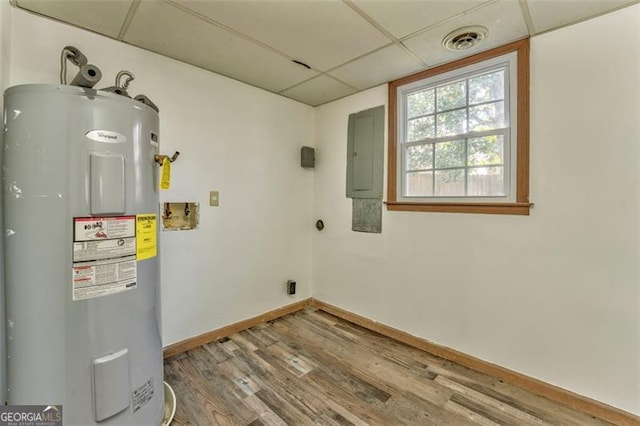 utilities with water heater, visible vents, and electric panel