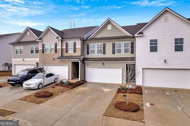 view of property featuring an attached garage, board and batten siding, and driveway