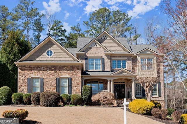 craftsman-style house featuring brick siding