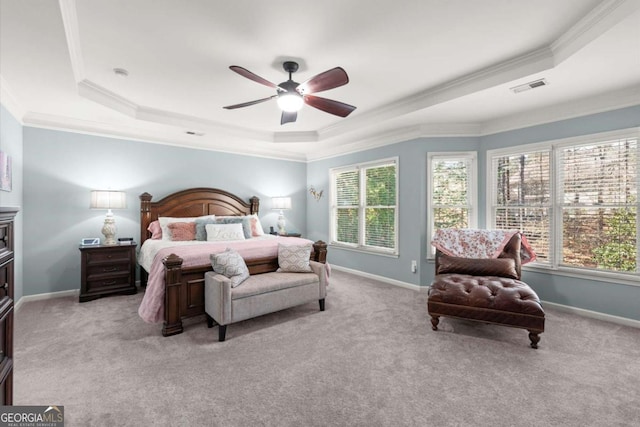 bedroom with a raised ceiling, baseboards, and visible vents