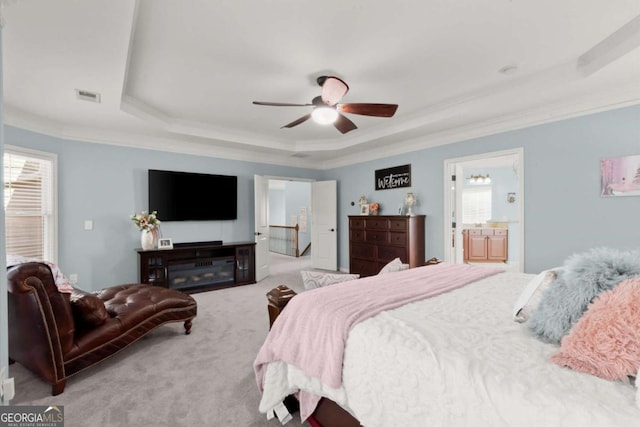 carpeted bedroom with visible vents, a raised ceiling, a ceiling fan, and crown molding