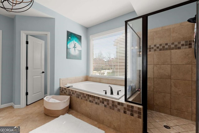 full bath with tile patterned flooring, a shower stall, and a garden tub