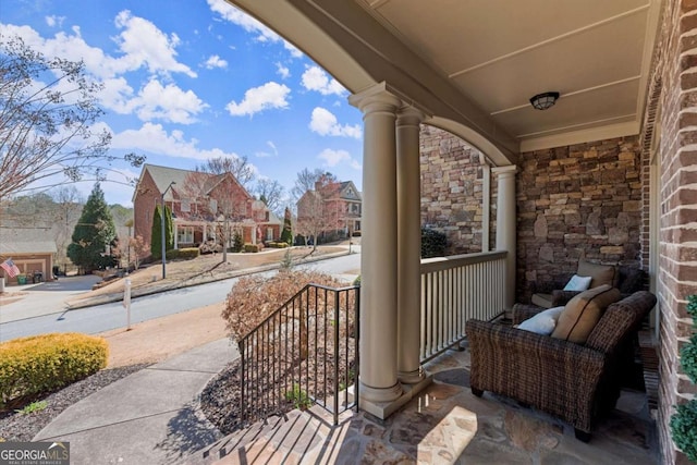 view of patio / terrace with a residential view and a porch