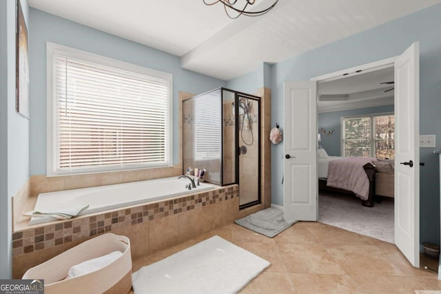 full bath with connected bathroom, a stall shower, tile patterned flooring, a bath, and a chandelier