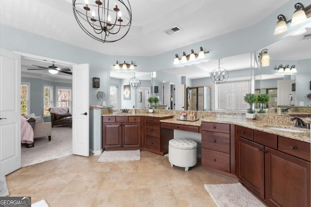 full bathroom featuring visible vents, ceiling fan with notable chandelier, a shower with door, connected bathroom, and a raised ceiling